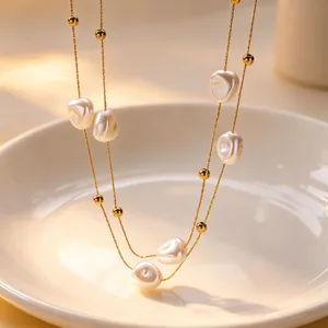 Exquisite double-layer baroque pearl necklace with gold chain, elegant and chic jewelry design.