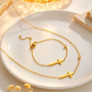 Gold titanium steel cross necklace and bracelet jewelry set, elegant design details.