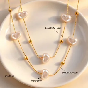 Detail view of double layer baroque heart pearl necklace with gold beads, titanium steel.