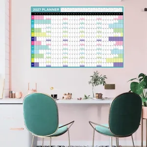 Detailed view of the 2027 planner wall calendar hanging in a stylish pink room interior.