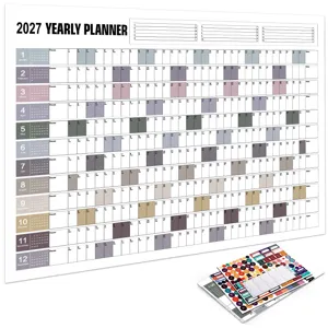 Close-up detail of the 2027 yearly wall planner showing monthly grids, notes area, and matching stickers.