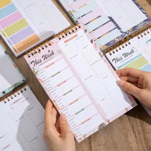 Weekly meal planner notepad detail showing spiral binding, tearable pages, and food lists.