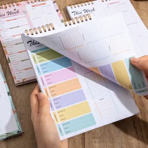 A5 weekly meal planner notebook with spiral binding and tearable pages for diet tracking.