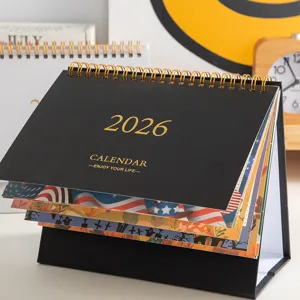 Detailed view of 2026 desktop calendar with black cover and golden typography setup.