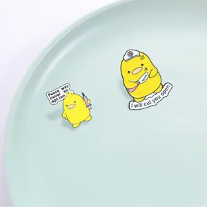 Cute funny yellow duck enamel brooch pin set, nurse and syringe quirky cartoon accessory details.