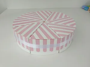 Close-up of pink and white striped cake slice favor boxes, ideal for weddings and party gifts.