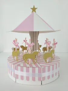Pink and white carousel cake box with gold glitter unicorn and bows for wedding favors.