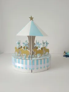 Carousel cake box detail, blue white striped candy gift box with gold glitter horses and bow.