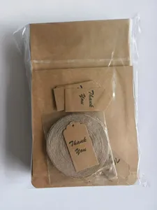 Kraftpapier-Geschenktüten mit Juteschnur und Dankeschön-Etiketten für Bäckerei und Geschenke Detail.