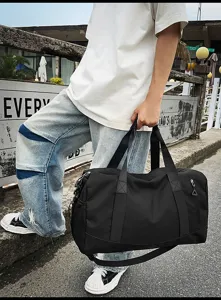 Large capacity black sports gym duffel bag for travel fitness training portable wear.
