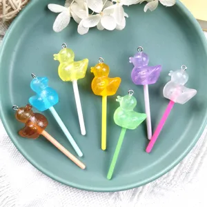 Detailed view of colorful resin little duck candy charms, DIY handmade jewelry making pendants.