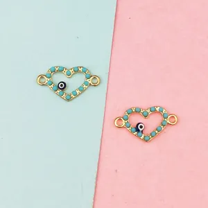 Detailed close-up of gold heart charms with blue evil eye and turquoise beads for DIY crafting.