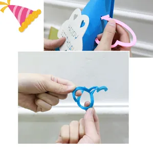 Detailed view of DIY felt birthday hat assembly with cloud and heart pieces for party decor.