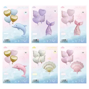 Ocean theme foil balloon set with dolphins, mermaid tails, and shells for birthday party decor.