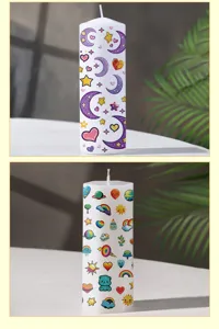 Detailed view of white pillar candles featuring colorful cartoon prints with stars and moons.