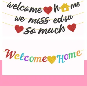 Glitter welcome home banner party decoration details and colorful hanging letter banner display.