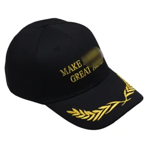 Detail view of black cotton baseball cap with gold embroidery and wheat pattern on brim.