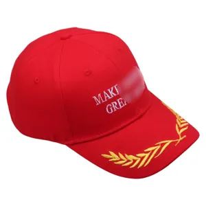 Detailed view of red cotton baseball cap with white embroidery and gold wheat leaf brim.