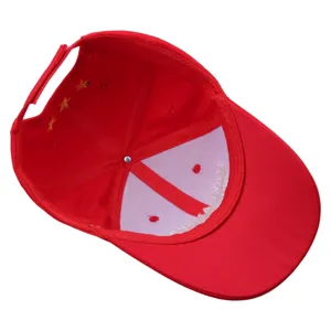 Red cotton baseball cap interior detail view with embroidery stars and inner lining text.