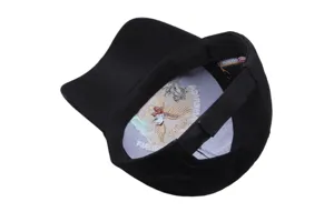 Detail view of black baseball cap inner lining with patriotic eagle embroidery and text.