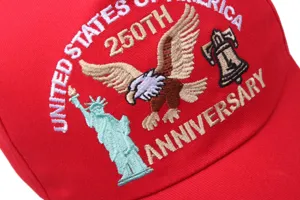 Detailed close-up of embroidered US 250th anniversary baseball cap with eagle and liberty bell.