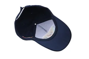 Dark blue baseball cap interior detail, showing premium embroidery and breathable design.