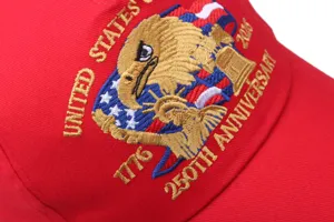 Detailed shot of red baseball cap with 250th anniversary USA eagle embroidery craftsmanship.