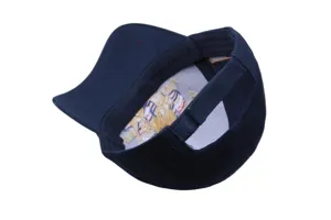 Detail view of the inner embroidered eagle crest and adjustable strap on the navy baseball cap.