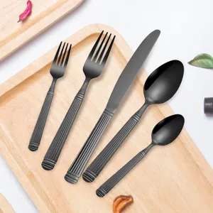 Matte black stainless steel flatware detail view, elegant fluted handle design cutlery.