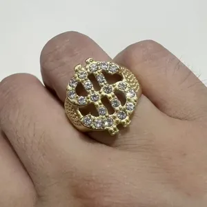 Detailed close-up view of the luxury gold dollar sign rhinestone ring worn on the finger.