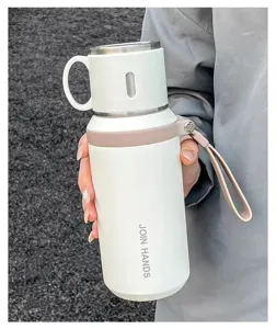 Exhibición detallada de la botella de agua aislada al vacío de acero inoxidable con correa.