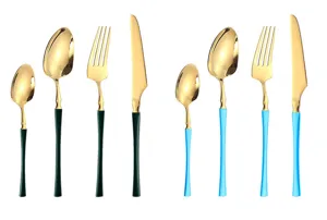 Close-up detail view of gold stainless steel cutlery set with colorful handles, fork and knife.