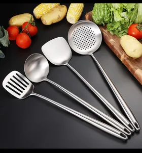 Stainless steel kitchen utensils detail view with durable metal spatulas and spoons.
