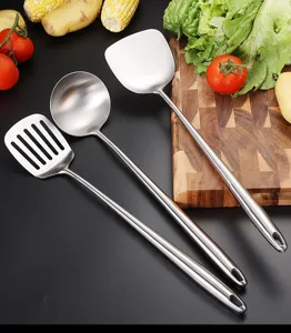 Stainless steel kitchen utensils set with slotted turner, soup ladle and spatula for cooking.