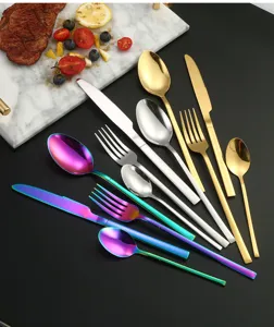 Stainless steel cutlery set detail, multi-color knife fork spoon display for dining table.