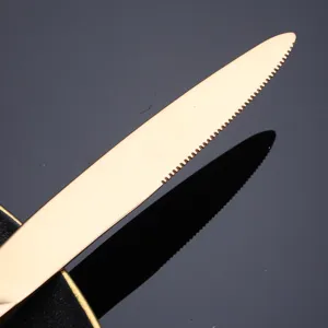 Rose gold stainless steel steak knife with serrated edge for modern kitchen table settings.