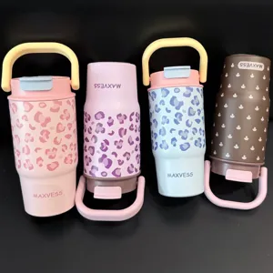 Detail view of four colorful leopard print insulated tumblers with handles and flip lids