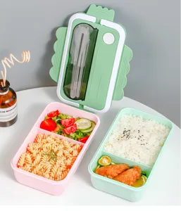 Detailed view of the partitioned lunch box with cutlery compartment and cute lace edge design.