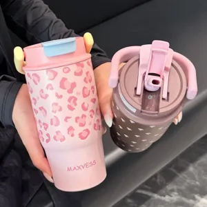 Close-up of pink leopard and brown heart print insulated tumblers with lid detail.