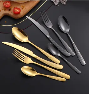 Stainless steel cutlery set with diamond textured handles in gold and black finishes.