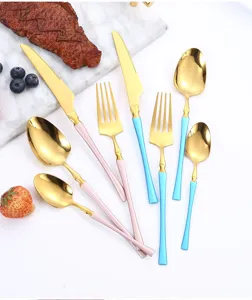 Stainless steel flatware set featuring gold finish with pink and blue handles for dining.