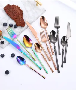 Stainless steel flatware set, multi-color cutlery including steak knife, fork and dessert spoon.