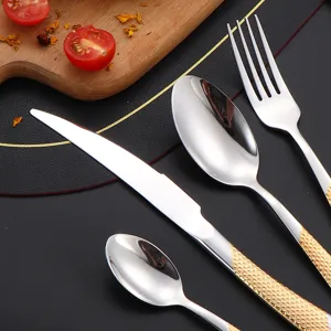 Stainless steel western cutlery set with gold textured handles, elegant steak knife, spoon and fork.