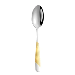 Stainless steel western dining soup spoon with gold textured handle main product view