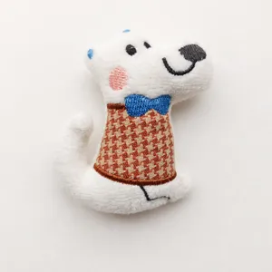Close-up detail of the cute white cartoon puppy plush toy pendant with plaid outfit.