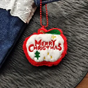 Christmas apple plush toy pendant detail view, soft plush material with cute holiday embroidery.