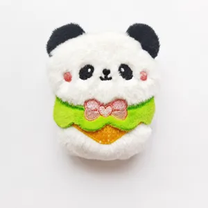 Cute panda plush toy detail view, soft stuffed animal pendant with green bib, compact size.