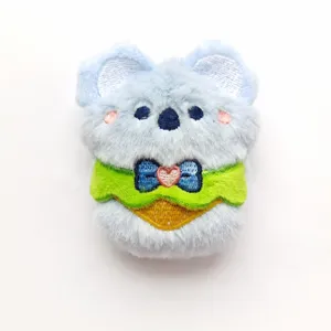 Close-up detail shot of the cute plush koala pendant, showing soft fabric and bow tie design.