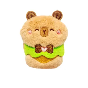 Cute capybara plush doll brooch with green apron, soft stuffed animal pendant for bags and clothes.