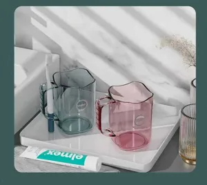 Transparent couple mouthwash cup set with wavy rim and handle, elegant bathroom toothbrush holder.